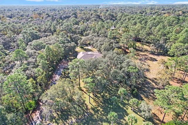 drone / aerial view featuring a wooded view