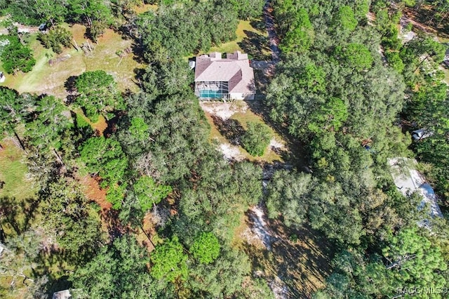 birds eye view of property with a wooded view