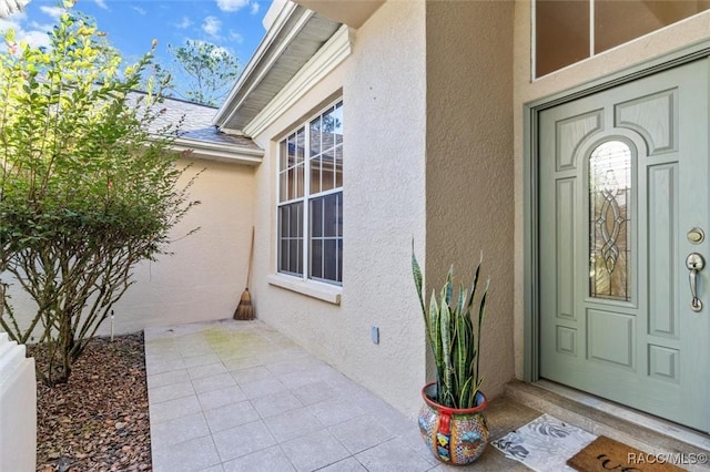 property entrance with stucco siding