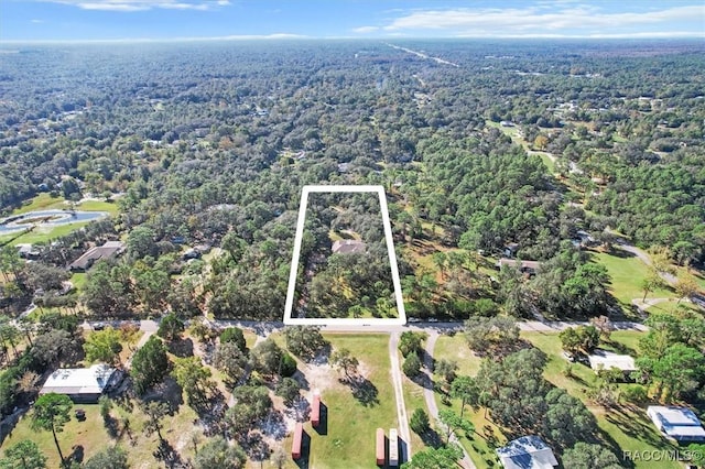 drone / aerial view featuring a forest view