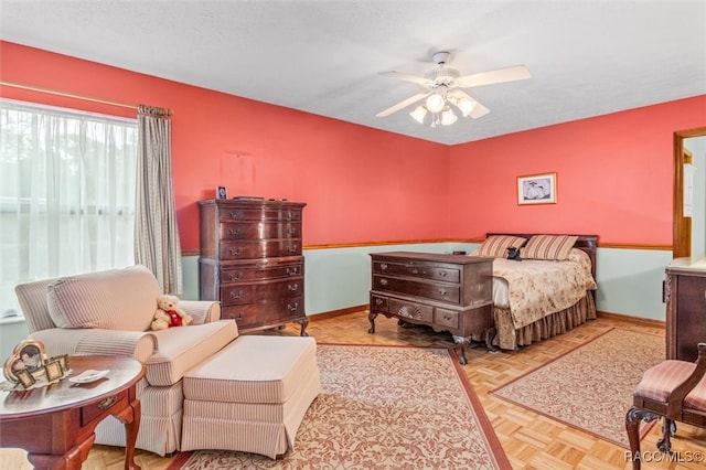 bedroom with light parquet floors and ceiling fan