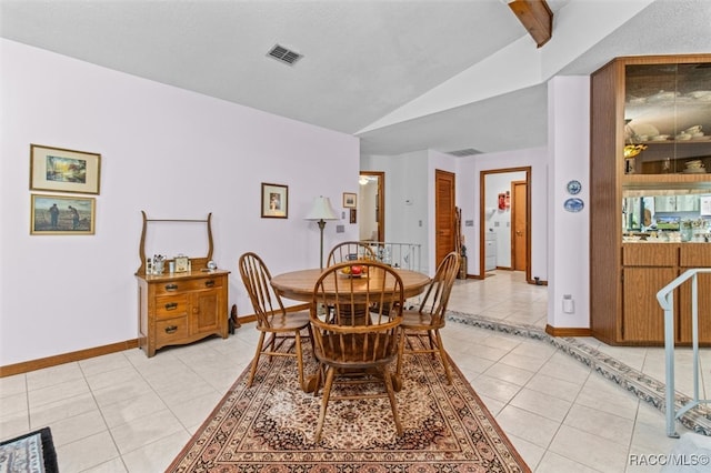 tiled dining area featuring lofted ceiling