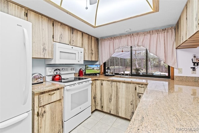 kitchen with sink, light tile patterned floors, and white appliances