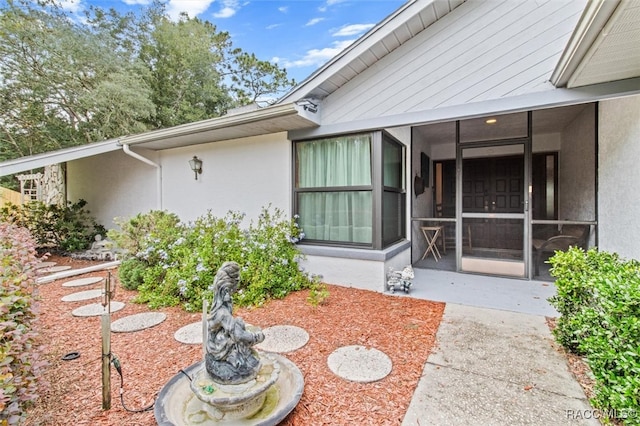 doorway to property with a patio area