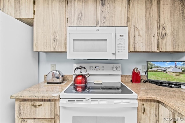 kitchen with light brown cabinets and white appliances