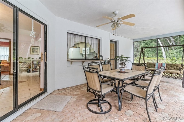 sunroom with plenty of natural light and ceiling fan