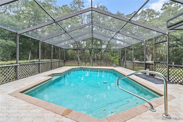 view of swimming pool with a patio and glass enclosure