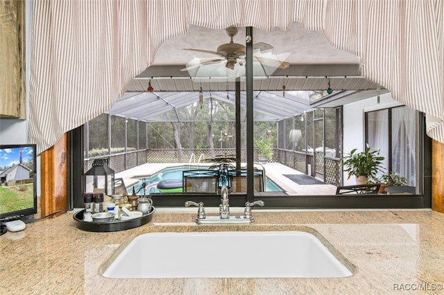 interior space with ceiling fan and sink