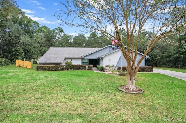 ranch-style home featuring a front yard