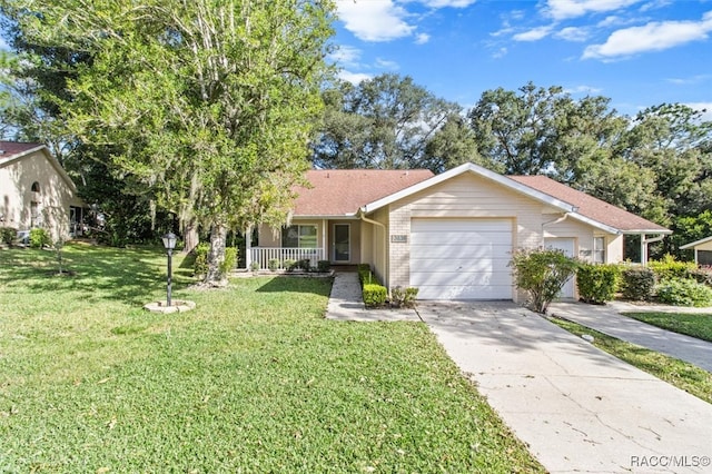 ranch-style house featuring covered porch, a front yard, and a garage