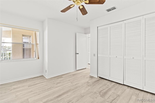 unfurnished bedroom with ceiling fan, a closet, and light hardwood / wood-style flooring