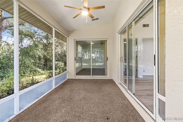 unfurnished sunroom with a wealth of natural light, lofted ceiling, and ceiling fan