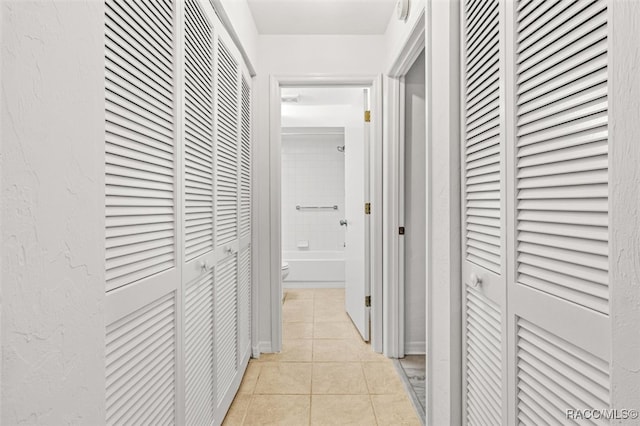 corridor featuring light tile patterned floors