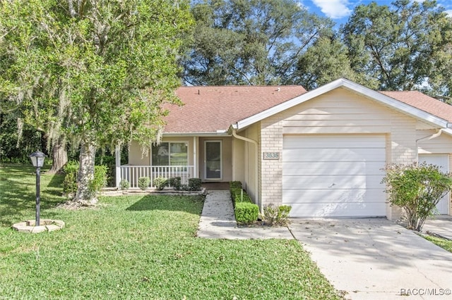 ranch-style house featuring a front yard, a porch, and a garage