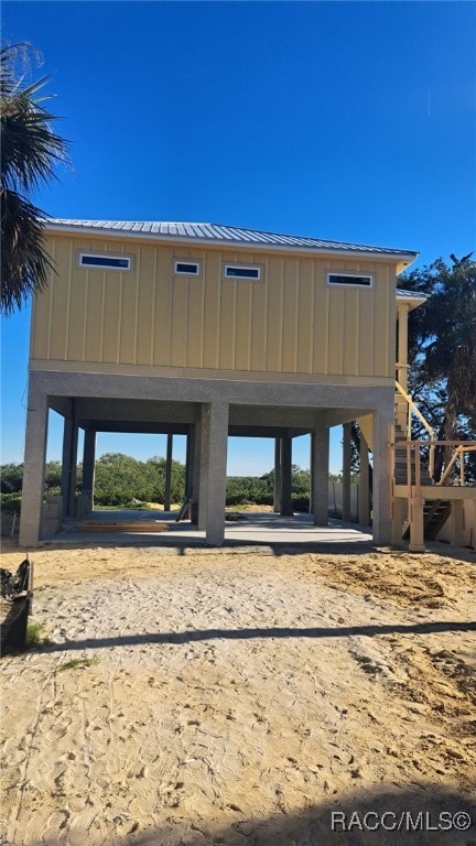 exterior space with metal roof and board and batten siding