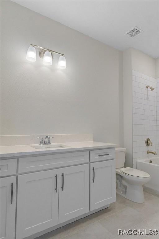 full bathroom with toilet, tile patterned flooring, shower / tub combination, and vanity