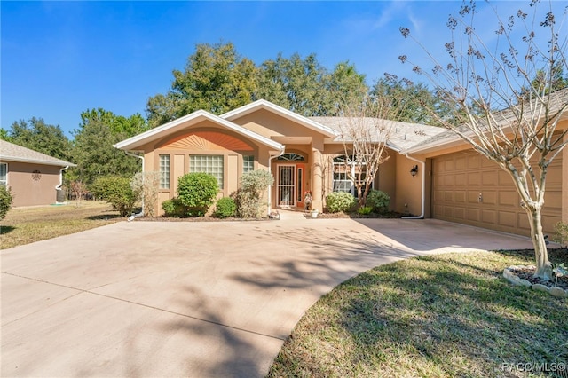 ranch-style home featuring a garage and a front yard