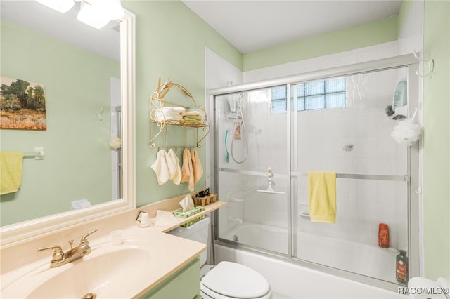 full bathroom featuring vanity, shower / bath combination with glass door, and toilet