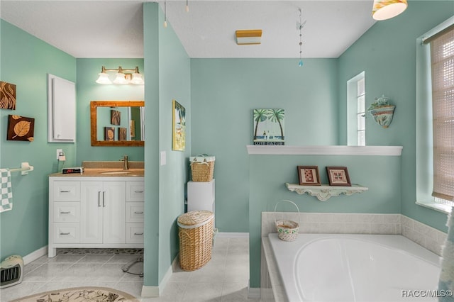 bathroom with tile patterned flooring, vanity, a tub, and a wealth of natural light