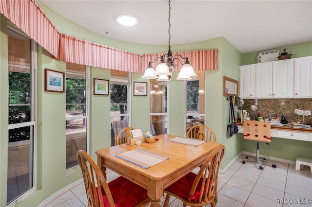 dining room with light tile patterned flooring and a chandelier