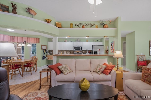 tiled living room featuring a notable chandelier