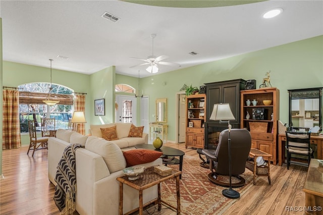 living room featuring hardwood / wood-style floors and ceiling fan