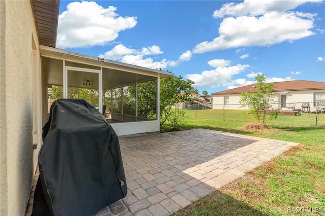 view of patio / terrace with a grill and a sunroom