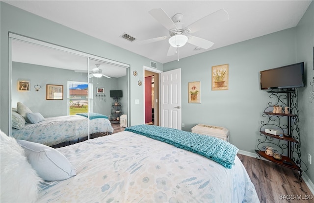 bedroom featuring hardwood / wood-style flooring, ceiling fan, and a closet