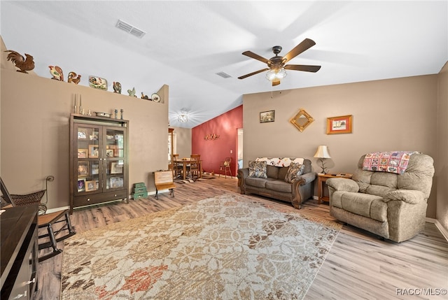 living room with ceiling fan, light hardwood / wood-style floors, and lofted ceiling