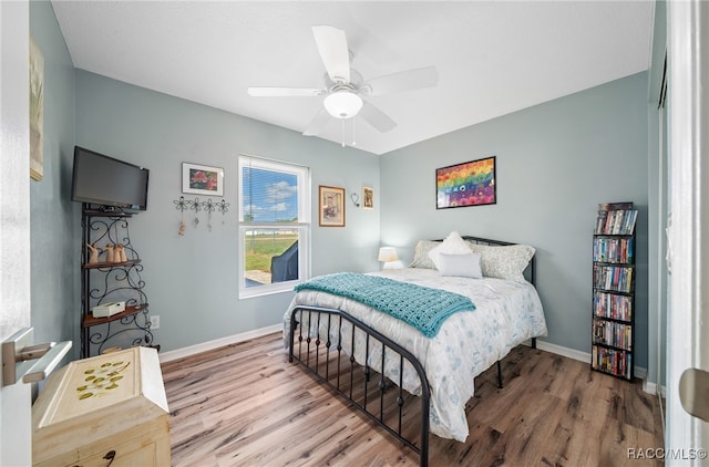 bedroom with ceiling fan and wood-type flooring