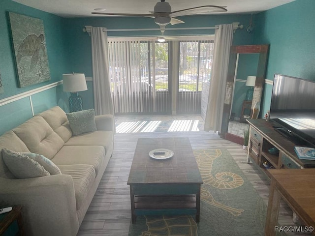 living room featuring wood finished floors and ceiling fan