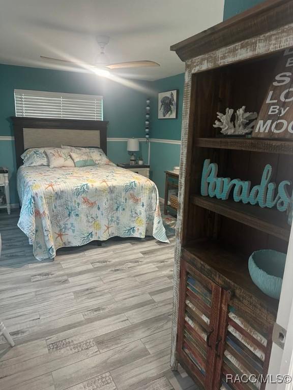 bedroom featuring ceiling fan and wood finished floors