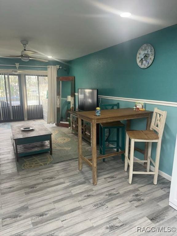 dining room featuring wood finished floors and ceiling fan