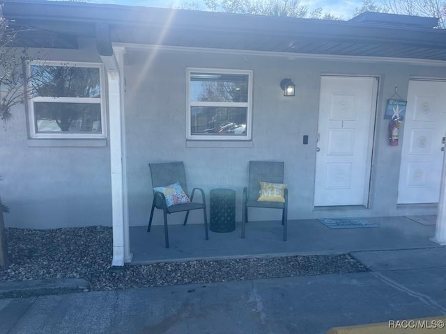 view of exterior entry featuring stucco siding