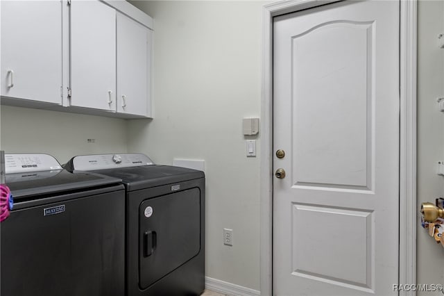 laundry area with washing machine and dryer and cabinets