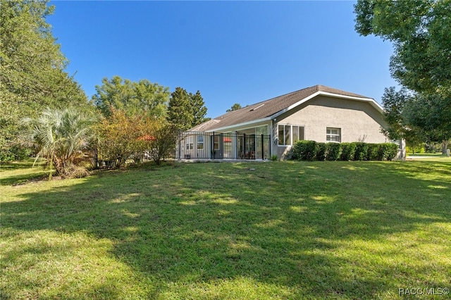 rear view of property with a yard