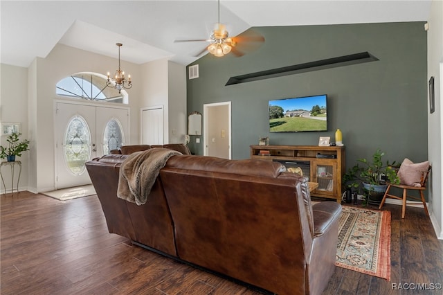 living room with dark hardwood / wood-style floors, ceiling fan with notable chandelier, high vaulted ceiling, and french doors