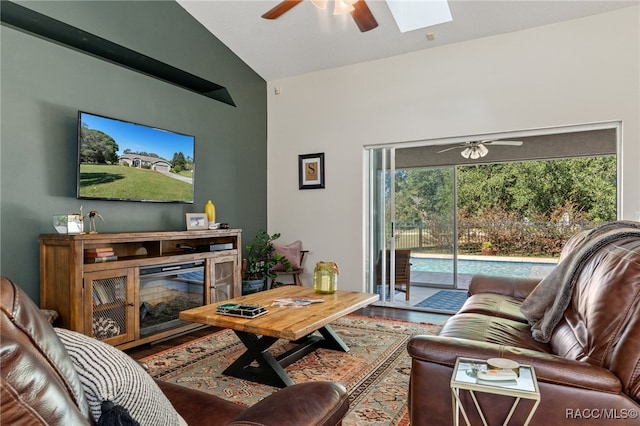 living room featuring vaulted ceiling with skylight and hardwood / wood-style floors