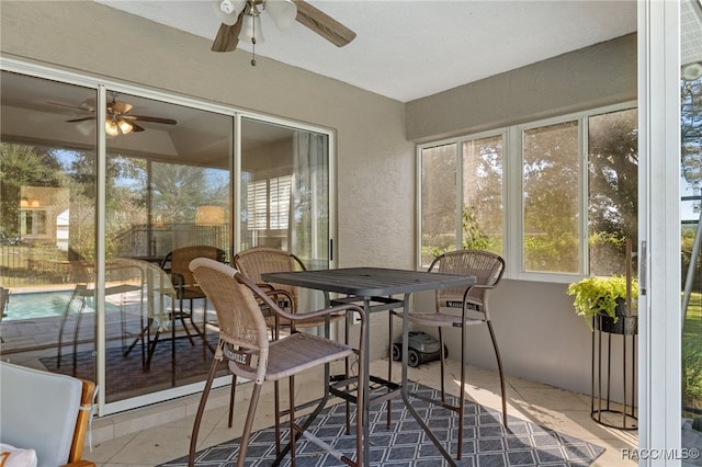 sunroom featuring ceiling fan