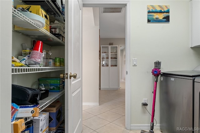 pantry featuring washing machine and clothes dryer