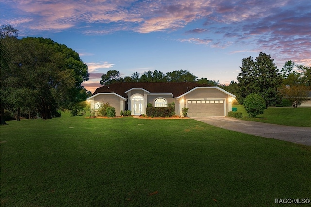 single story home with a yard and a garage