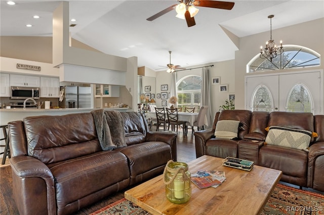 living room featuring plenty of natural light, wood-type flooring, and high vaulted ceiling