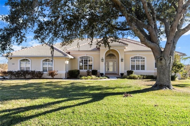 mediterranean / spanish-style house with a front yard