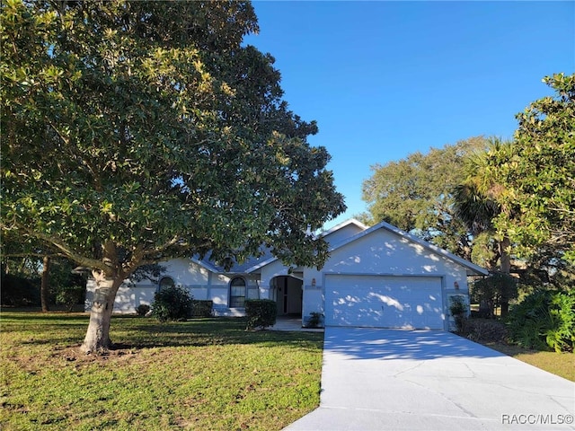 view of front of house with an attached garage, a front lawn, and concrete driveway