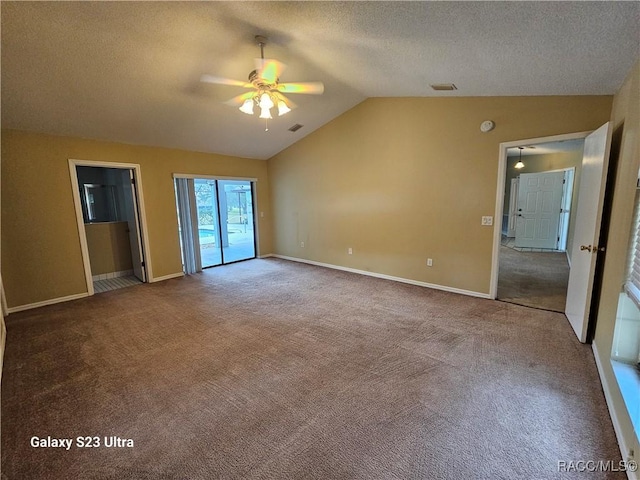 carpeted empty room featuring a textured ceiling, ceiling fan, and lofted ceiling