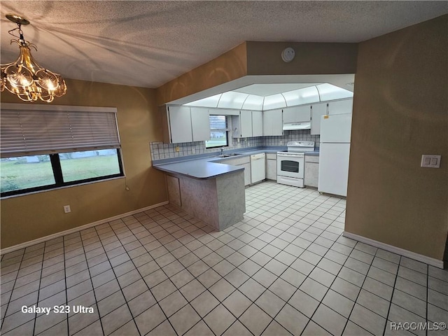 kitchen with electric range, white fridge, a textured ceiling, decorative light fixtures, and white cabinets