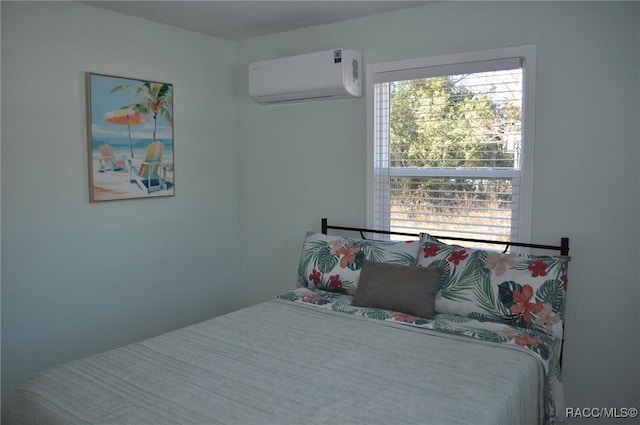 bedroom featuring an AC wall unit