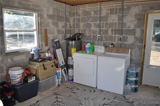 clothes washing area with electric water heater and washing machine and clothes dryer