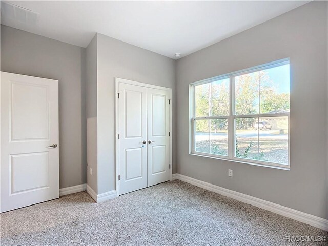 unfurnished bedroom with light carpet