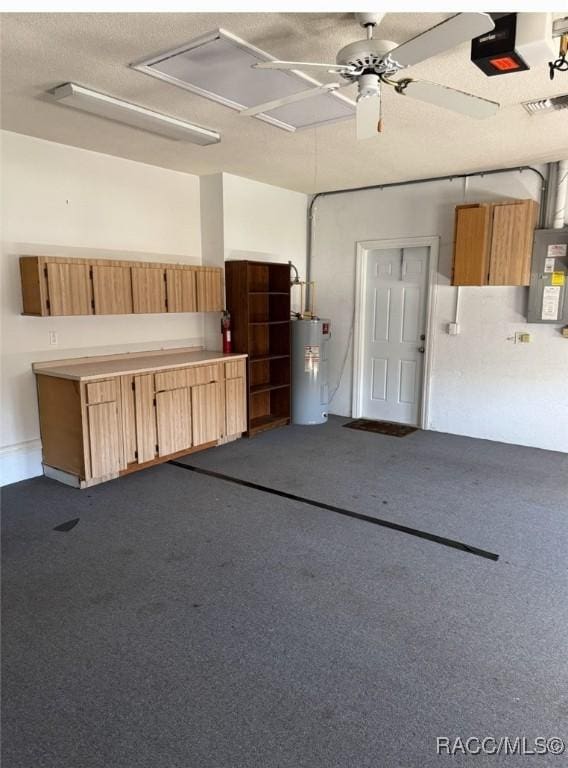 garage featuring electric panel, a garage door opener, visible vents, and electric water heater